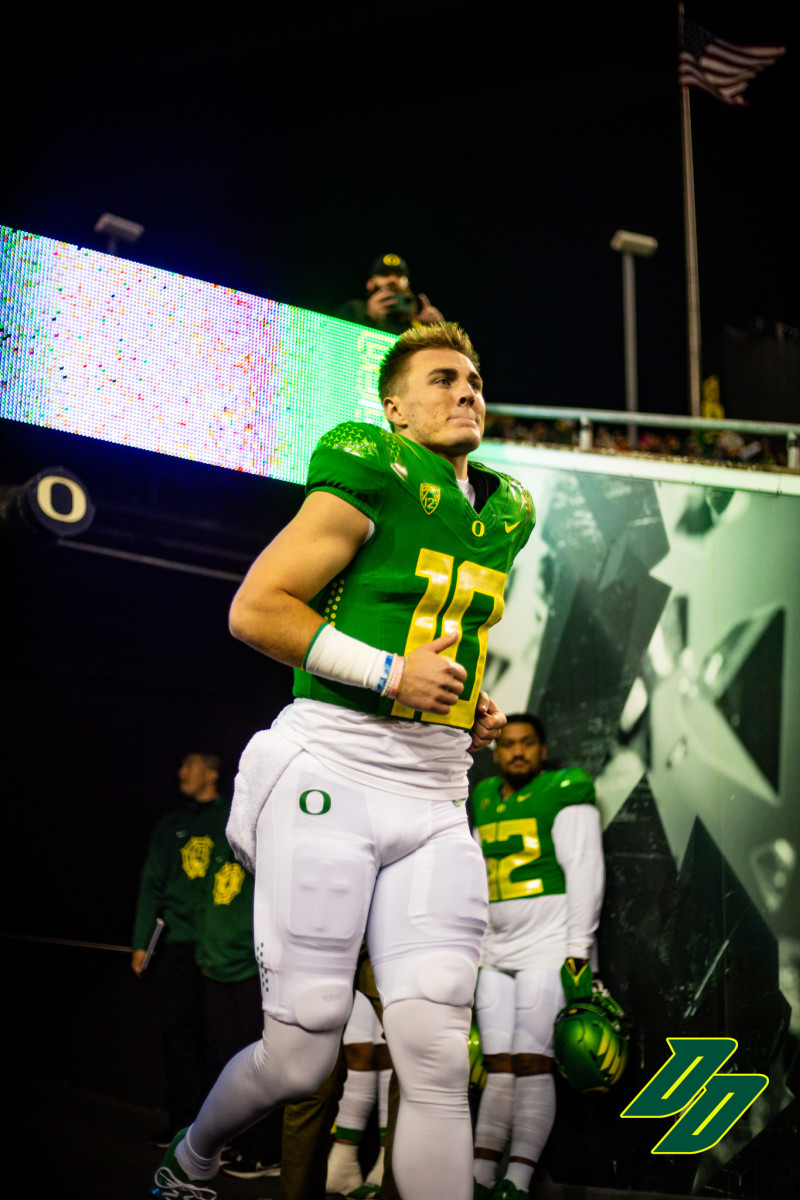 Oregon Ducks quarterback Bo Nix runs out of the tunnel during senior night ceremonies at Autzen Stadium.